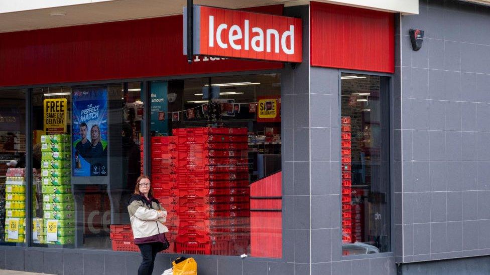 Woman outside Iceland store