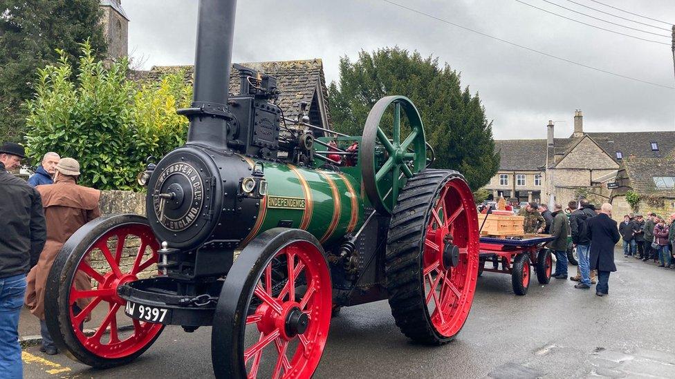 Steam tractor hauling a coffin