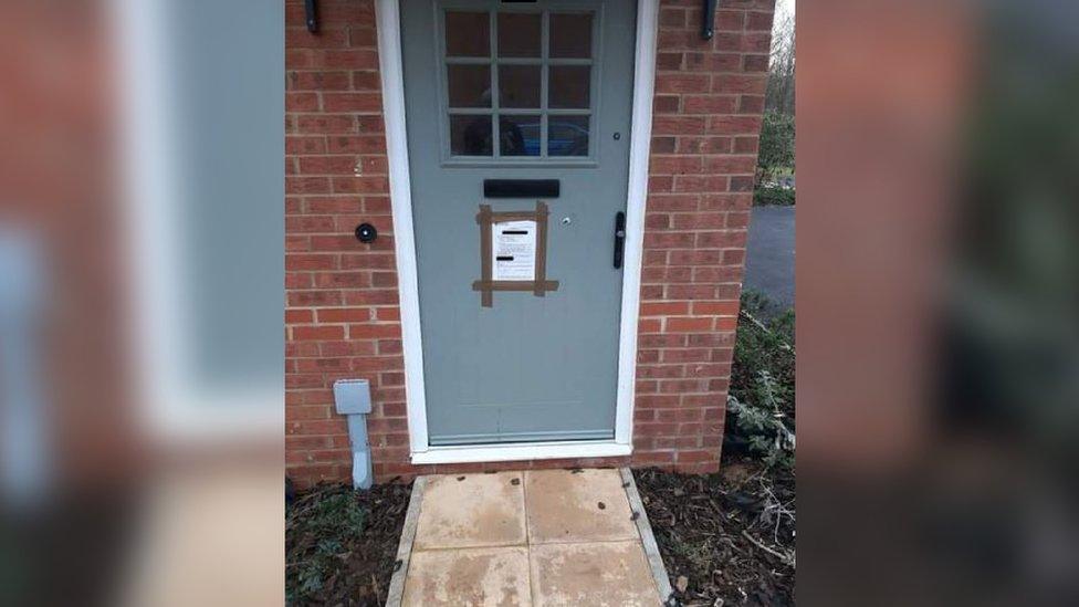 Door marked with closure order notice in Brize Norton, Oxfordshire
