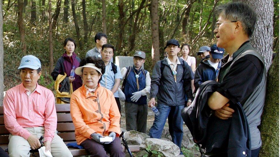 Mr Moon, then presidential chief of staff, climbing a mountain with then President Roh Moo-hyun.