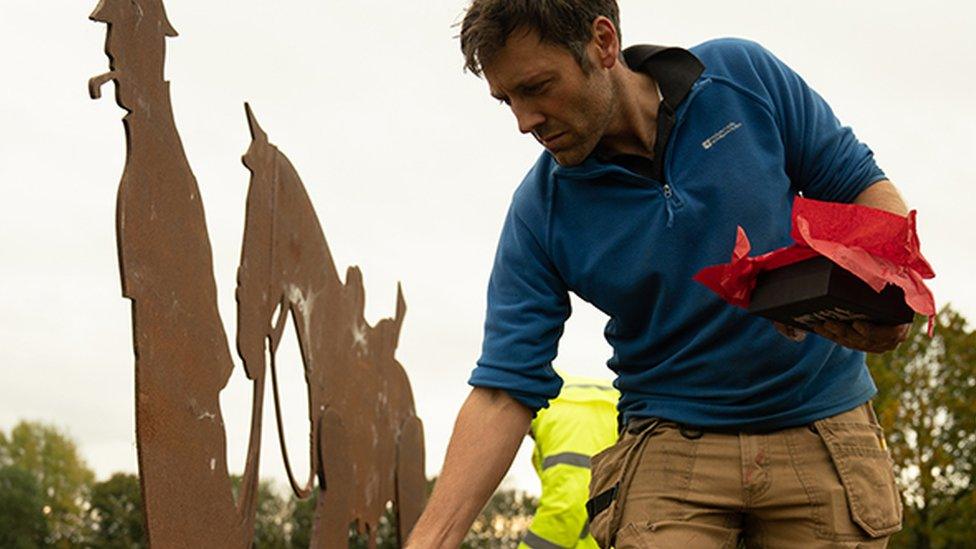 Man working on sculpture