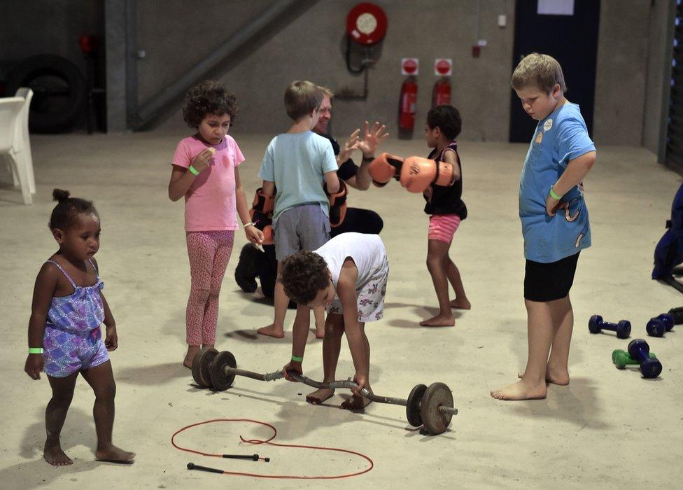 Children entertain themselves in a temporary cyclone shelter in the town of Ayr in far north Queensland as Cyclone Debbie approaches on 28 March 2017.