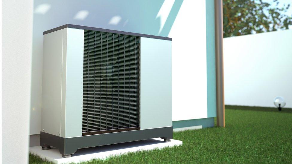 3d image of air source heat pump on the side of a house