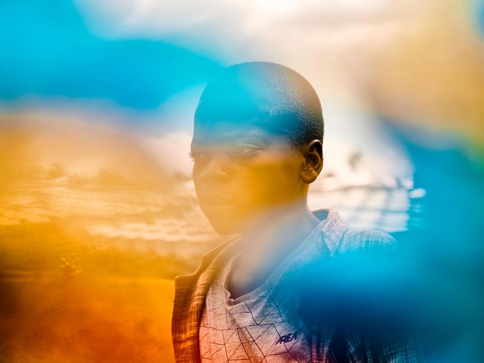 Jonathan, 13, poses for a portrait in an IDP camp Bunia province. Democratic Republic of Congo.