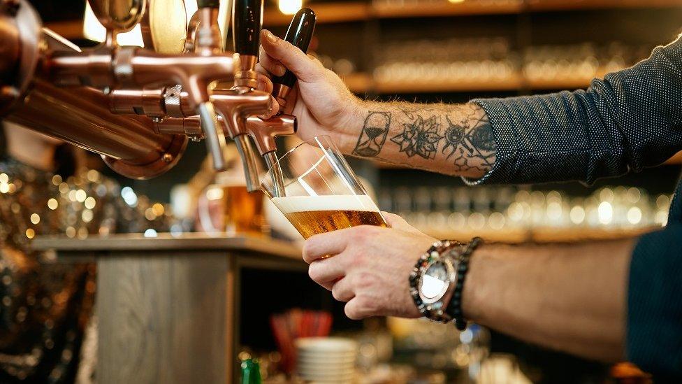 Bartender pulling pint of beer