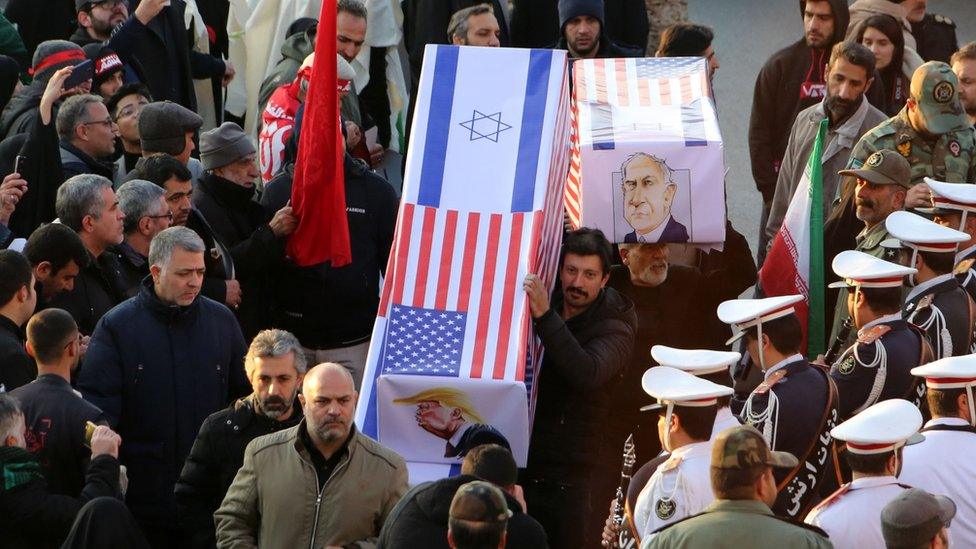 Mourners carry mock coffins with images of US President Donald Trump and Israeli Prime Minister Benjamin Netanyahu pasted on them in Tehran, 6 January 2020