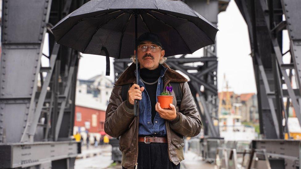 Artist holding pansy