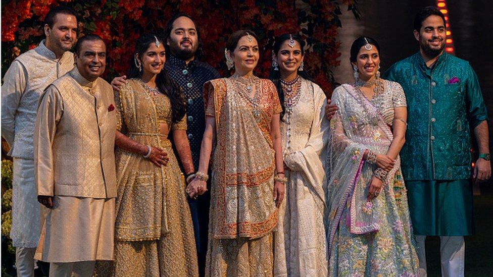 (L to R) Anand Piramal, Mukesh Ambani, Radhika Merchant, Anant Ambani, Neeta Ambani, Isha Ambani Piramal, Shloka Mehta Ambani and Akash Ambani, pose for the media during engagement of Anant Ambani and Radhika Merchant, at Antilia on January 19, 2023 in Mumbai, India.