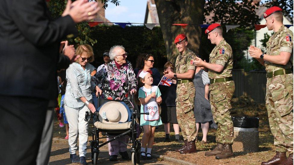 Joan Rich, her daughter Diane and a guard of honour by the Royal Military Police