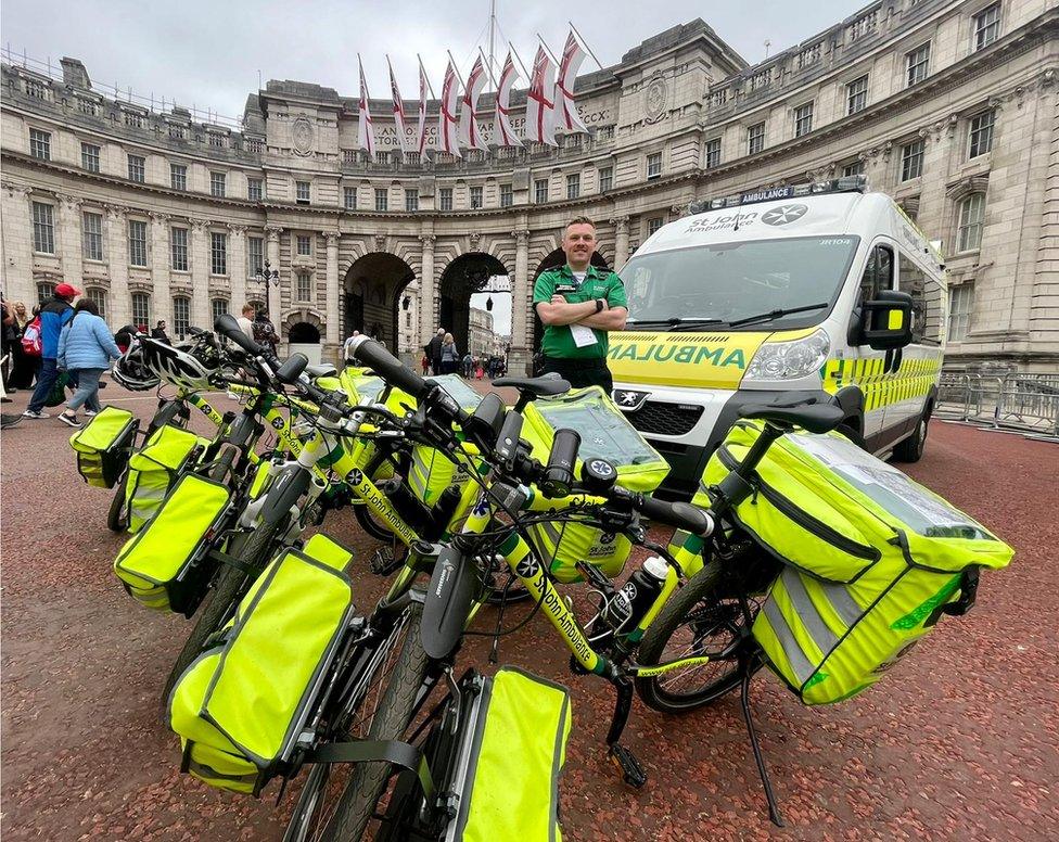 Ryan Young standing alongside St John Ambulance vehicles in London during his deployment for the Queen's Platinum Jubilee