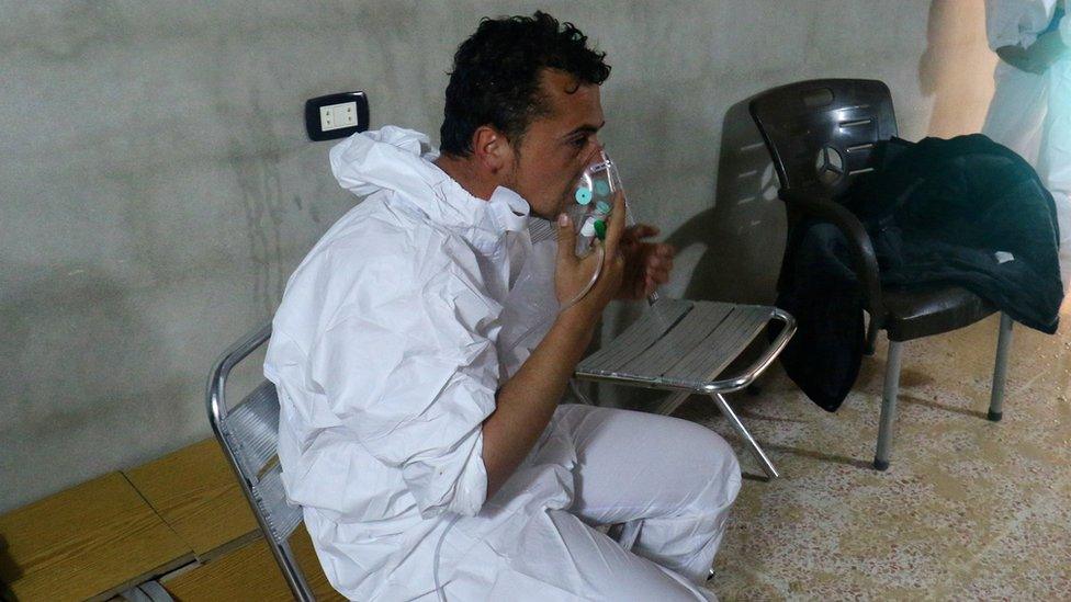 A man breathes through an oxygen mask after suspected gas attack in Khan Sheikoun