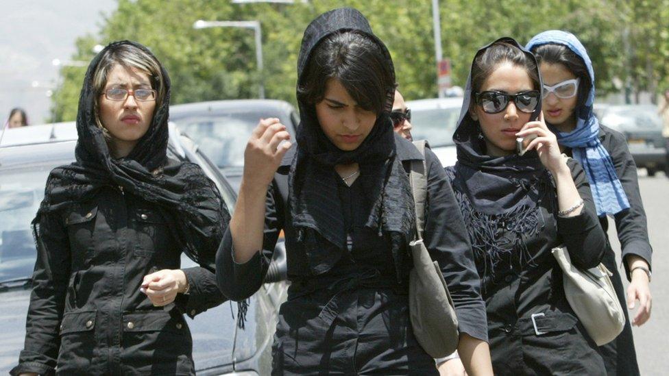 Iranian women in veils walk outside a shopping centre in Tehran on 2 June 2005