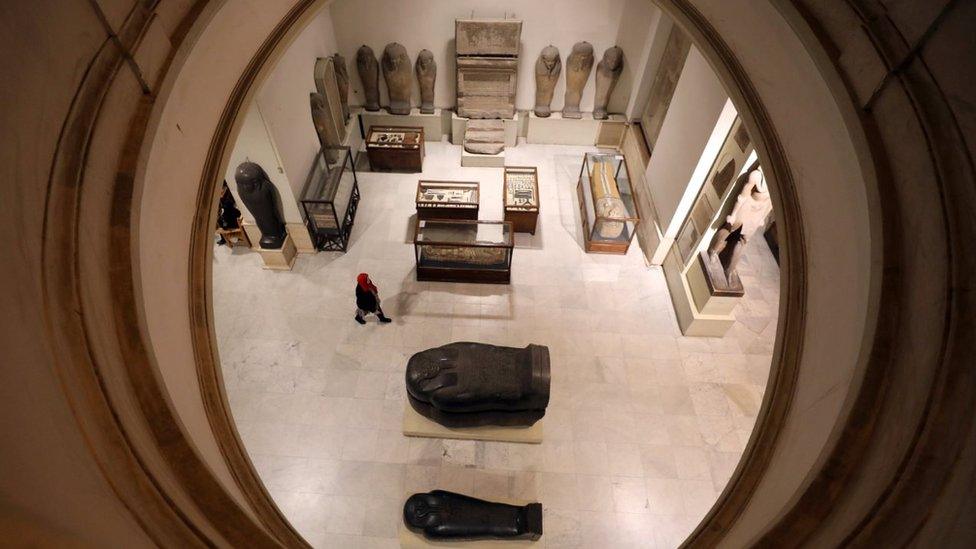 A visitor walks near artefacts inside the Egyptian Museum in Cairo, Egypt November 15, 2017.