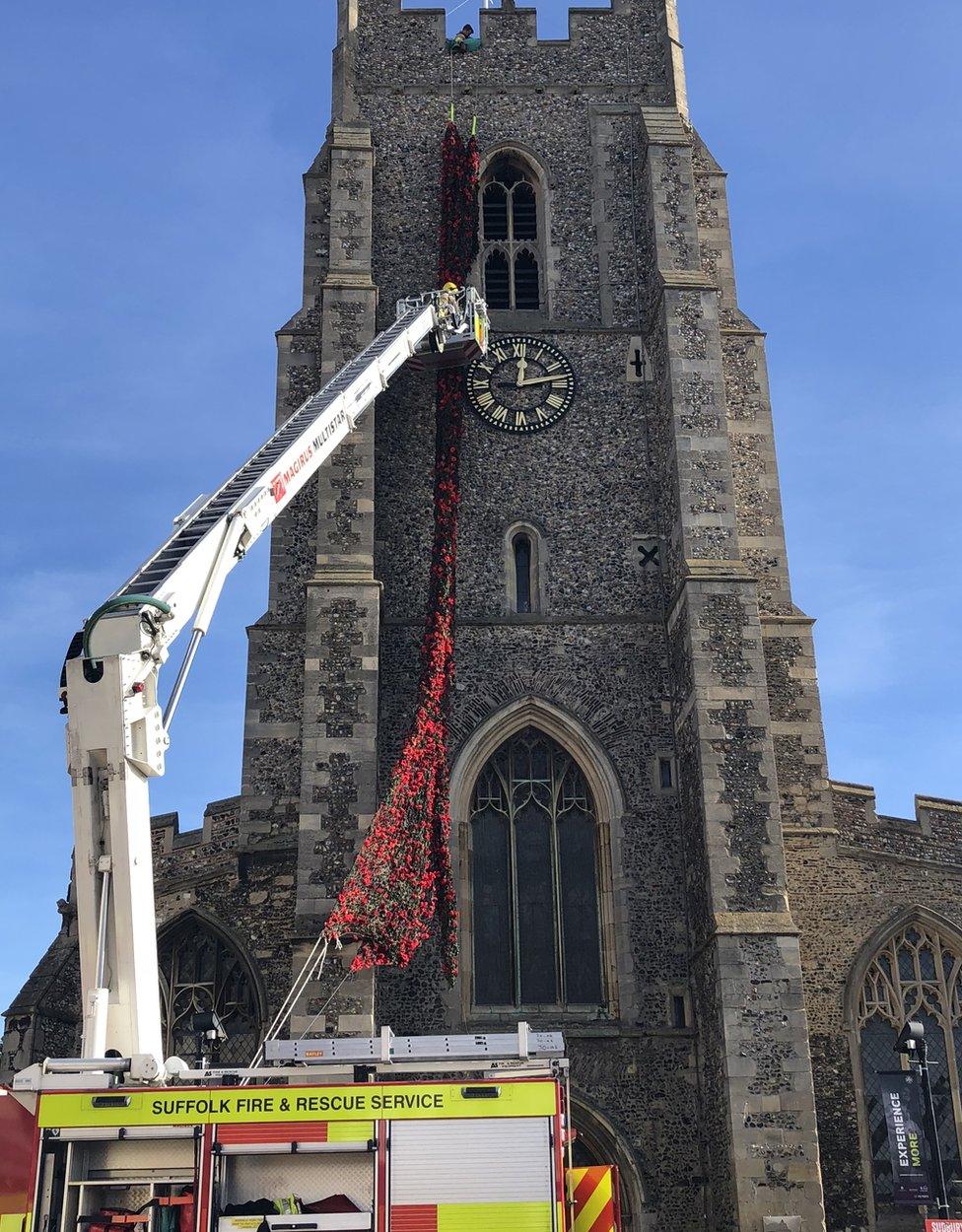 Fire crews putting the poppies on the church