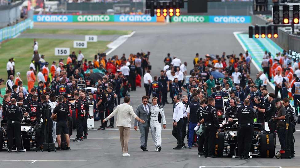 Actors Brad Pitt, Javier Bardem and Tobias Menzies are pictured at the British Grand Prix