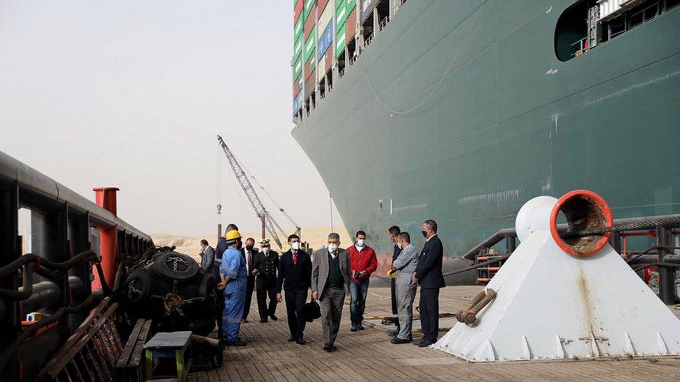 Egyptian officials inspect the operation to refloat the Ever Given ship