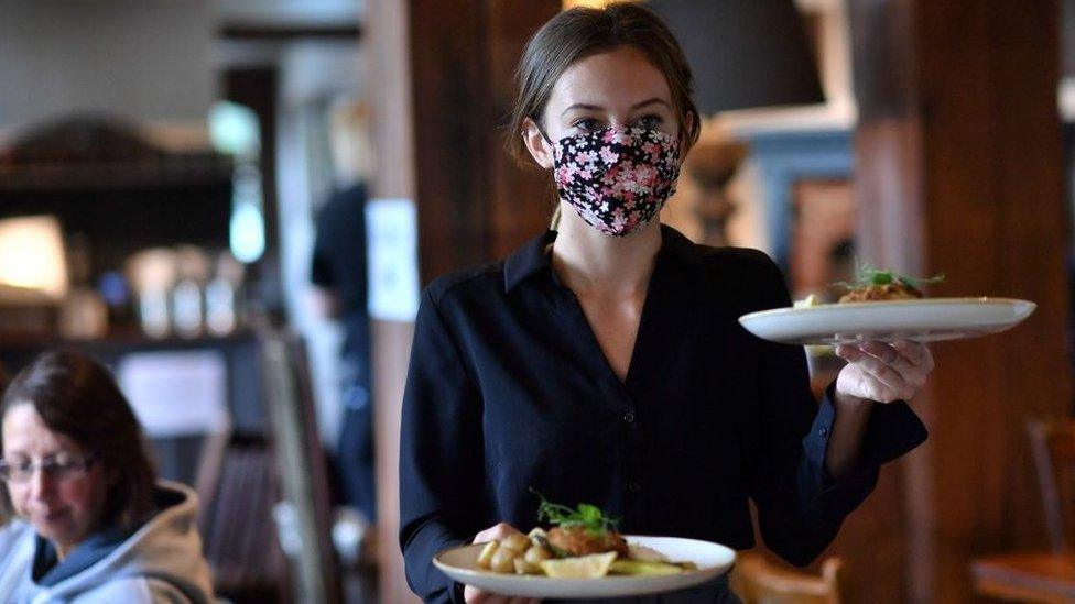 Waitress carries tray of food