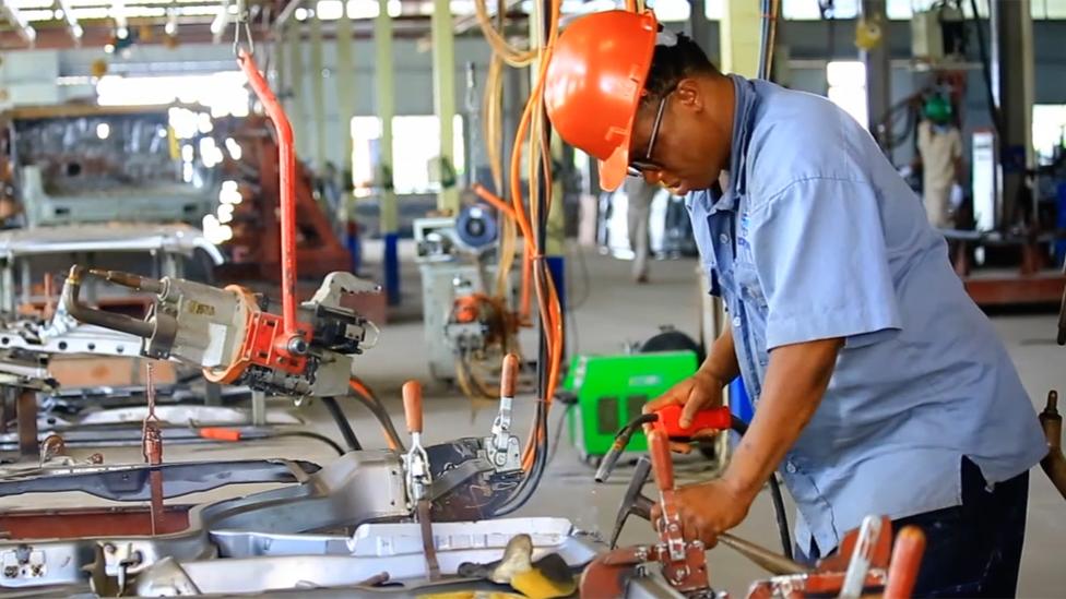 A factory worker in Nigeria