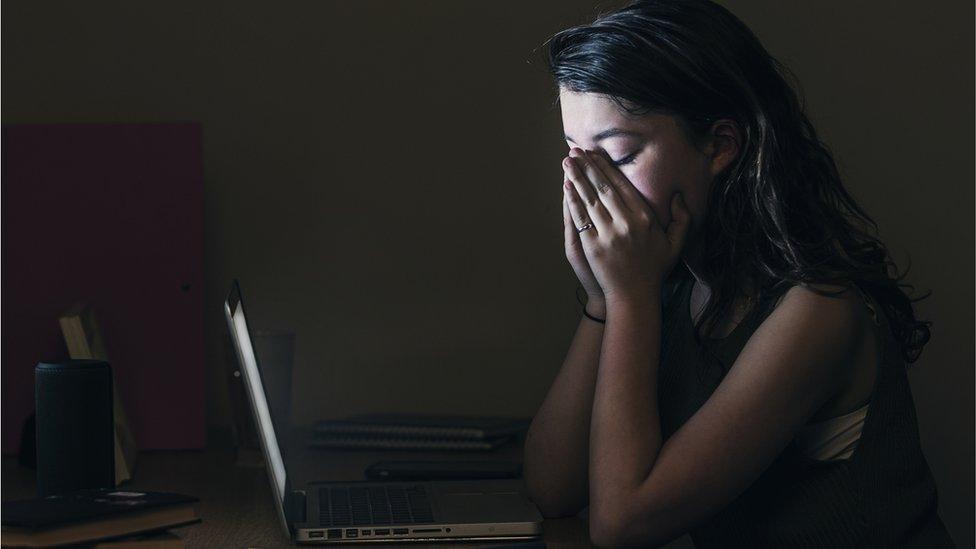 Upset girl on her laptop