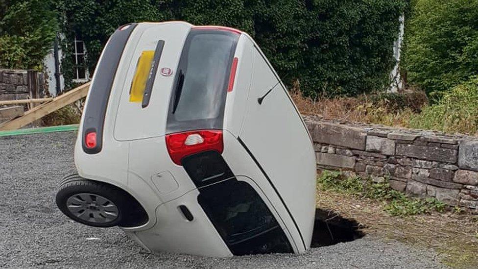 A car in a sinkhole