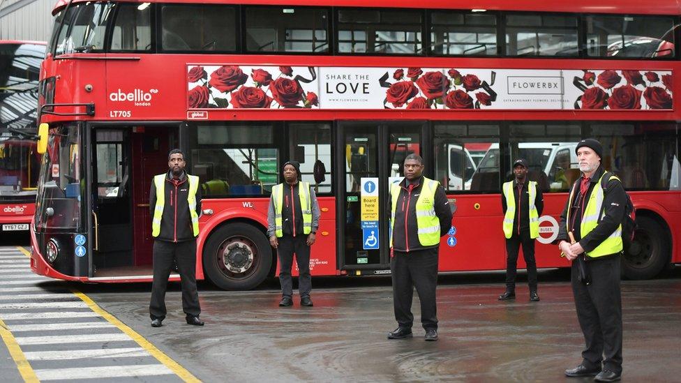 Staff stand inside Camberwell bus depot in London, during a minute"s silence to pay tribute to the NHS staff and key workers who have died during the coronavirus outbreak. PA Photo. Picture date: Tuesday April 28, 2020. Transport for London said its underground and bus network will be brought to a halt for the silence as the workforce honours its colleagues.