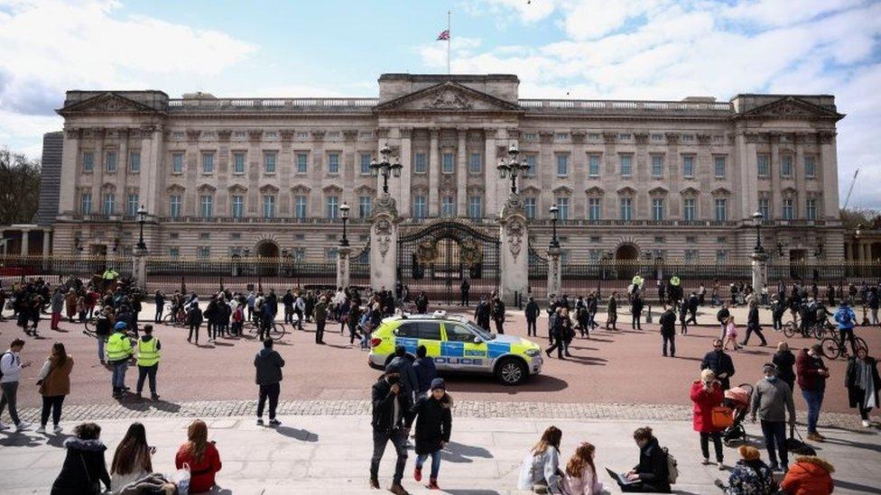 Mourners stand outside Buckingham Palace after it was announced that Britain"s Prince Philip, husband of Queen Elizabeth, has died at the age of 99, in London