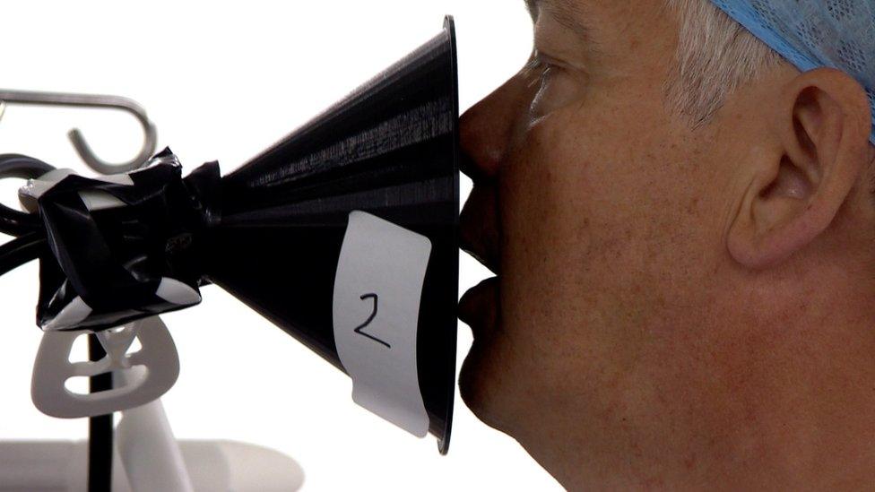 A singer being measured for aerosols