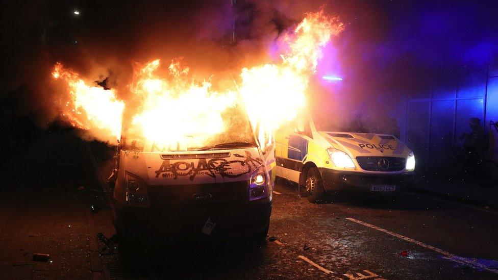 Police vans on fire