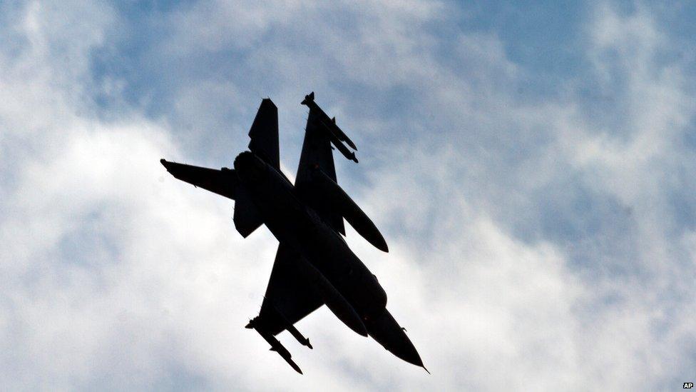 A Turkish Air Force fighter jet makes a landing approach at Incirlik Air Base, Turkey, Friday, Aug. 30, 2013.