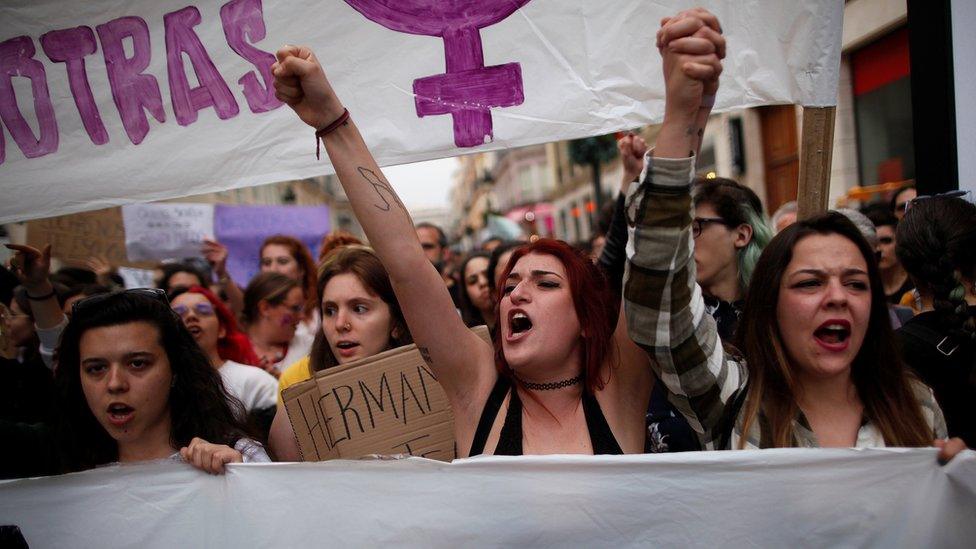 People shout slogans during a protest after a Spanish court condemned five men accused of the group rape of an 18-year-old woman, in Malaga