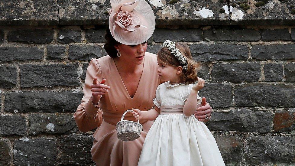 Duchess of Cambridge stands with her daughter Princess Charlotte, a bridesmaid