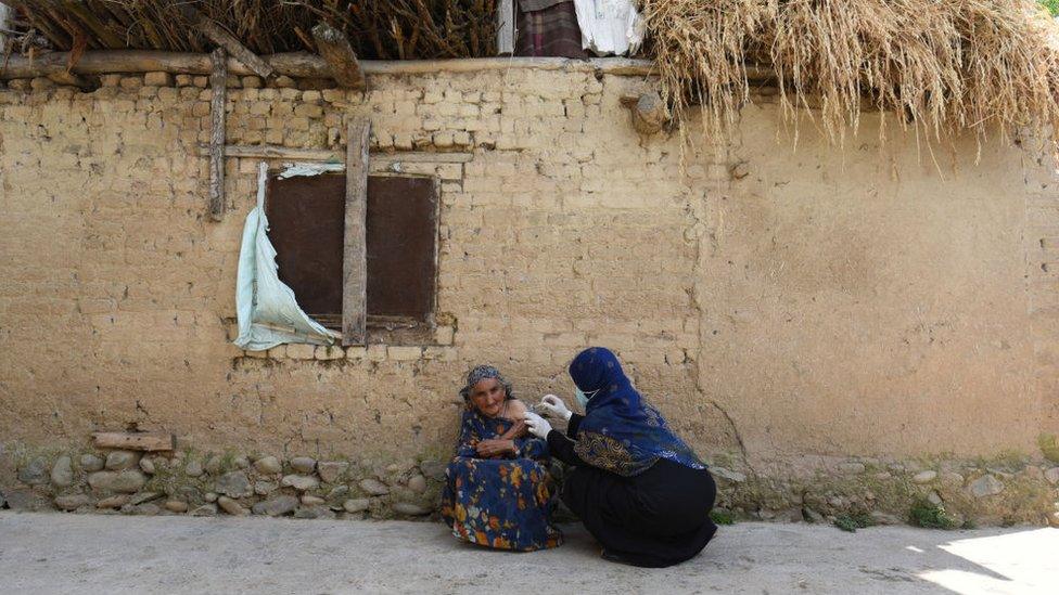 A health worker administers a Covid-19 vaccine to a beneficiary, during a door-to-door vaccination drive, at Tral village, on June 5, 2021 in Srinagar, India.