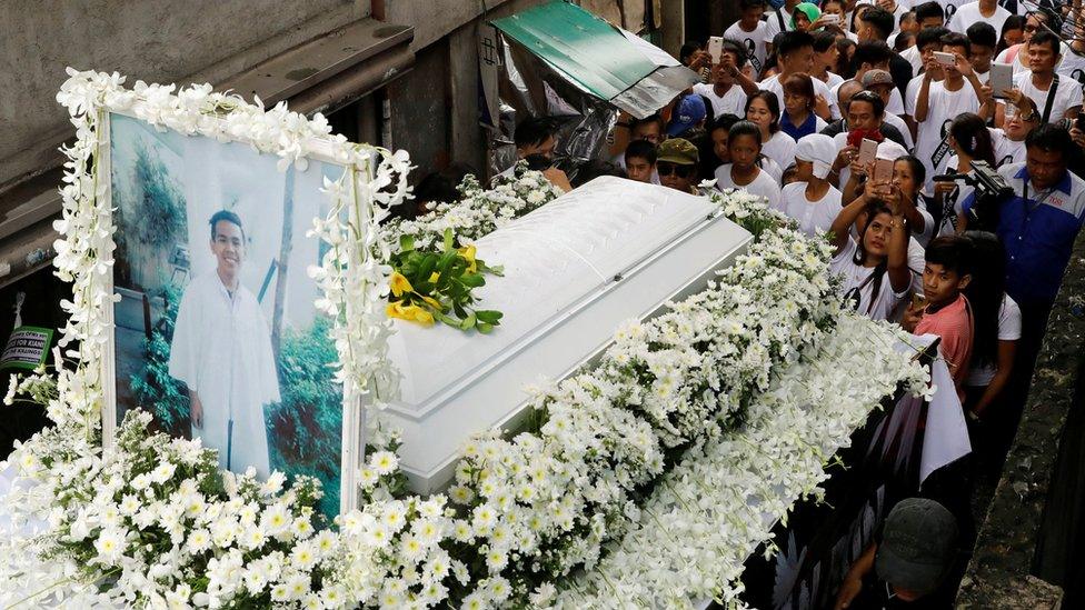 Mourners take part in the funeral march of Kian delos Santos, a 17-year-old student who was shot during anti-drug operations in Caloocan, Metro Manila, Philippines 26 August 2017