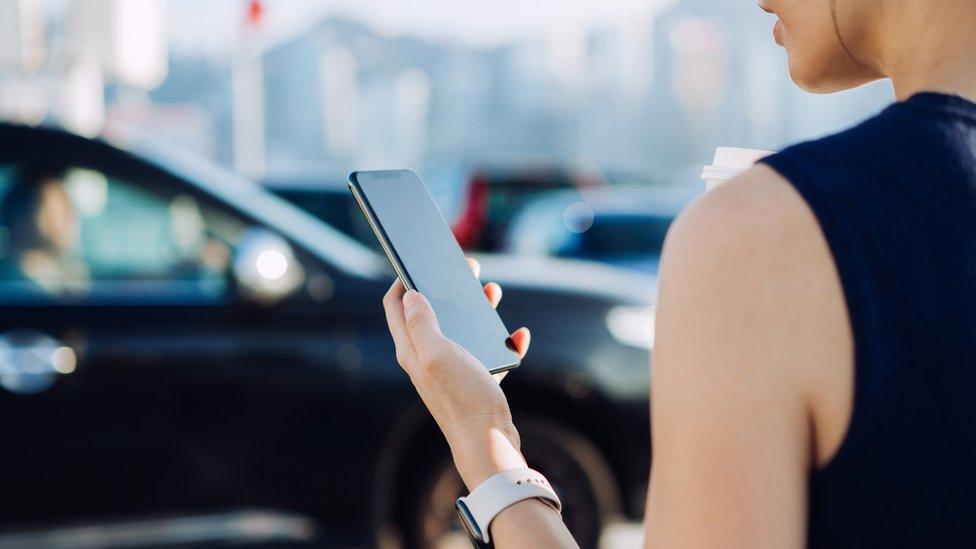 Woman looks at mobile phone