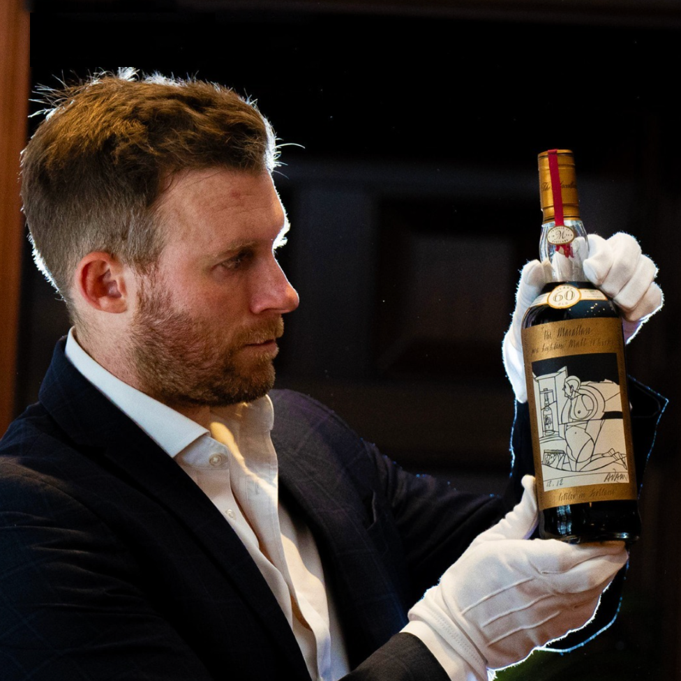 A bottle of Macallan Adami 1926 is held ahead of its auction in London