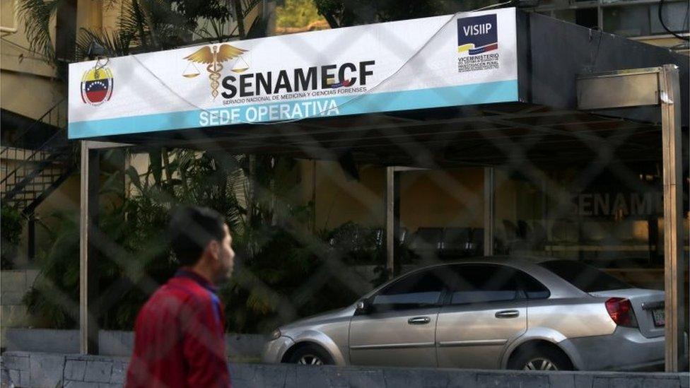 A man walks near the morgue of the Medicine National and Forensic Sciences Service (SENAMECF) in Caracas on March 9, 2019, the day after all activities were suspended due to an over 24-hour massive power outage, which affected even the morgue.