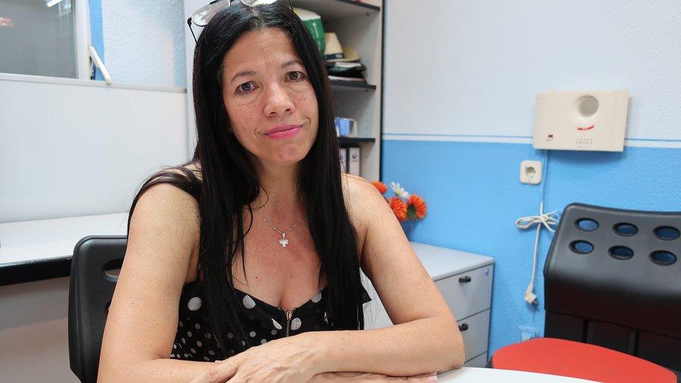 Maria Eugenia Carrillo sitting in an office space