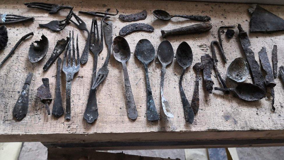 Objects found by renovators under a chimney in Block 17 at Auschwitz