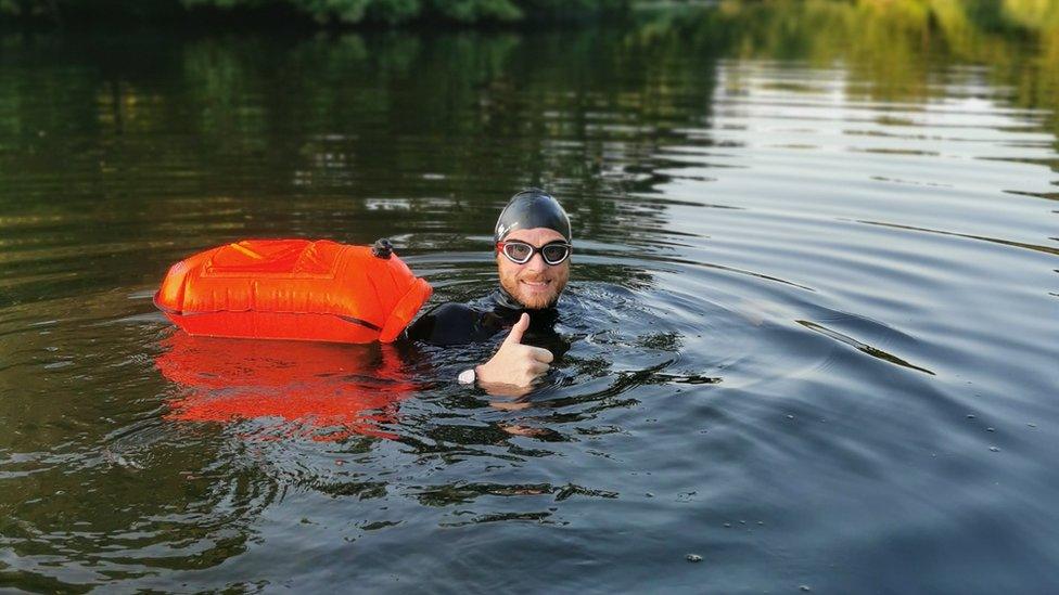 Craig giving thumbs up in the water