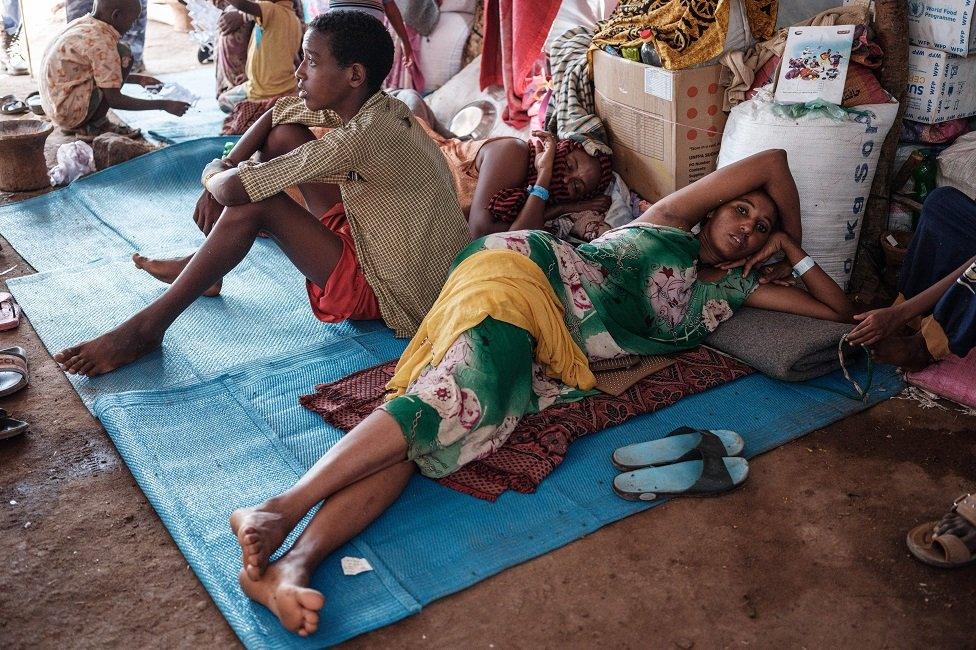 Ethiopian refugees who fled the Tigray conflict, rest in a makeshift shelter at Um Raquba reception camp in Sudan's eastern Gedaref state, on 3 December 2020