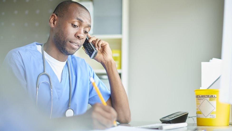 A doctor on the phone to a patient