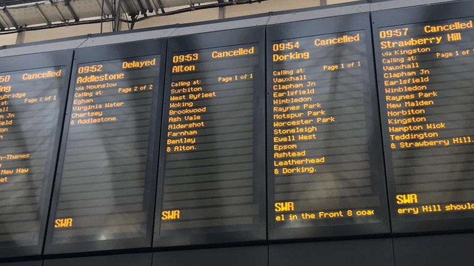 Departure boards showing delayed or cancelled messages