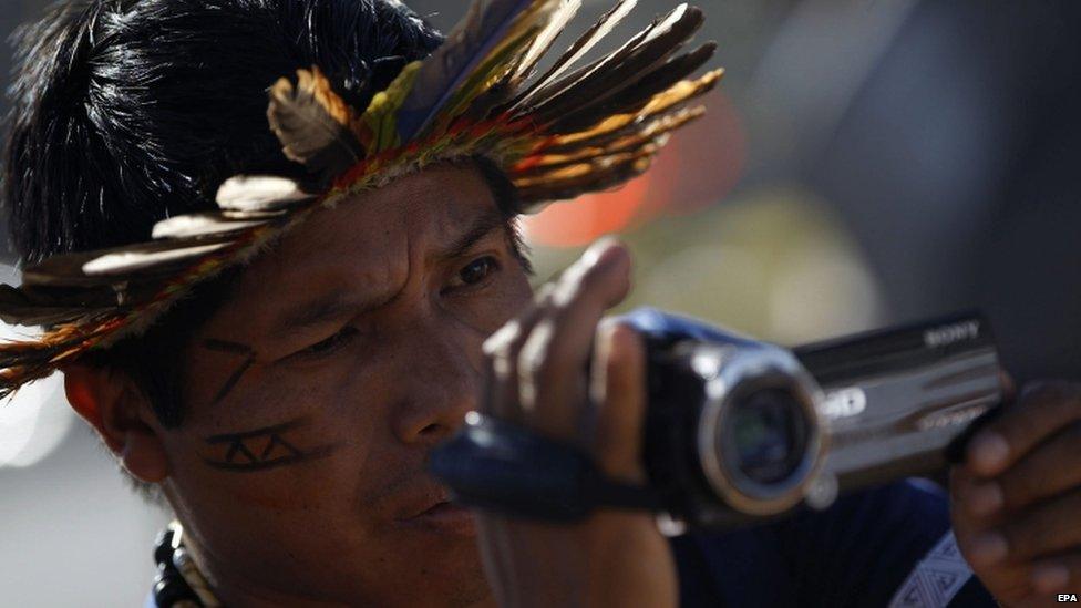 Member of the Guarani Kaiowa tribe films protest in Brasilia