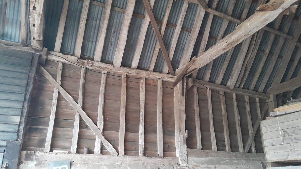 The beams inside an old barn