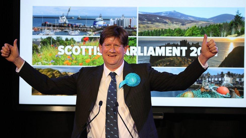 Scottish Conservative candidate Alexander Burnett has both his thumbs up, celebrating his win in Aberdeenshire West