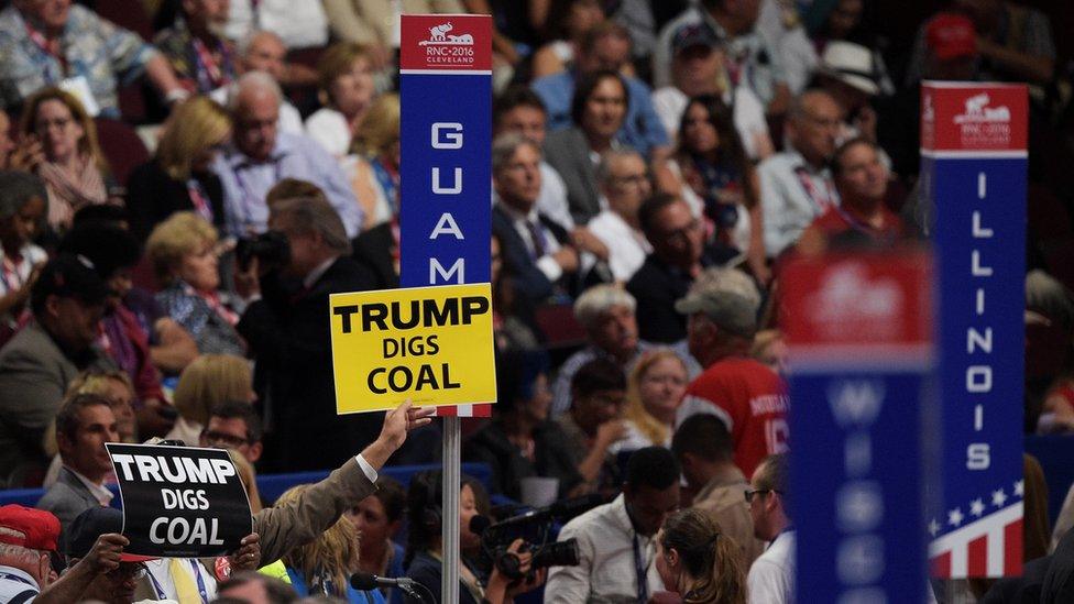 Trump digs coal sign