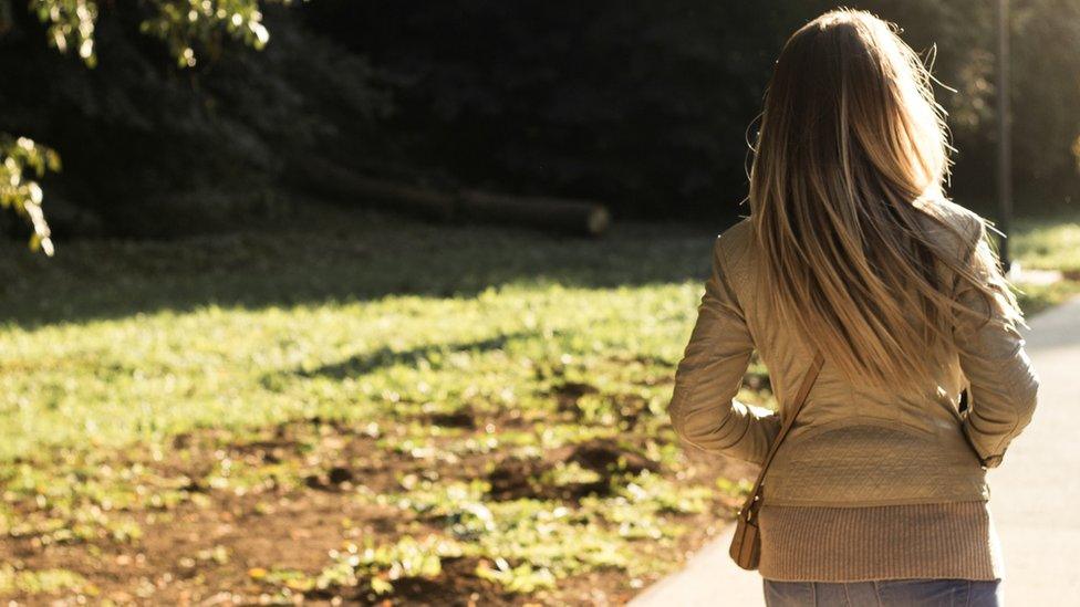 woman walking in woods