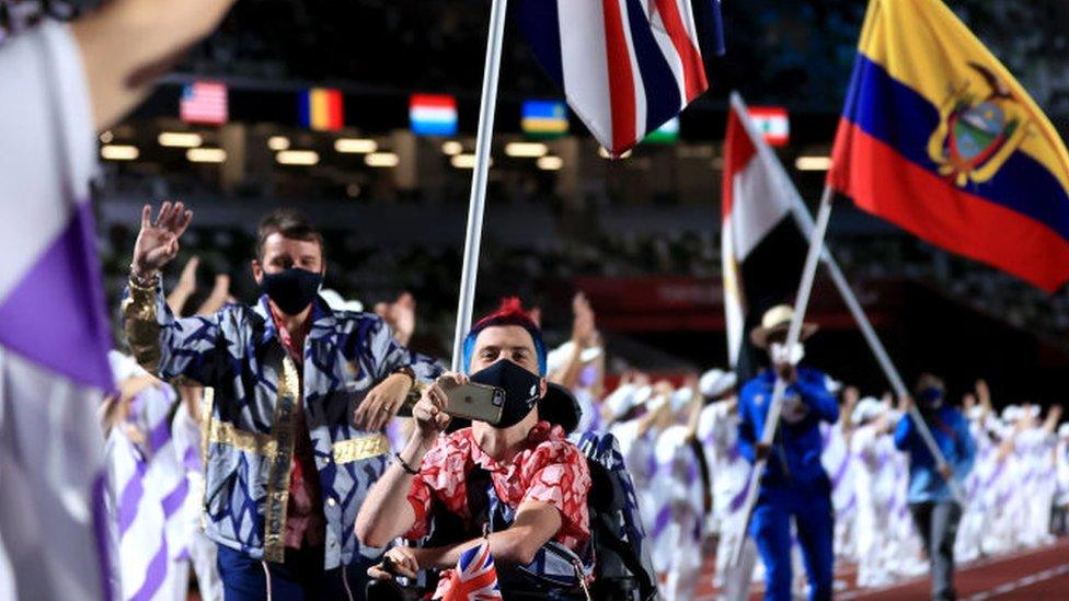 david-smith-carries-the-union-jack-through-the-stadium