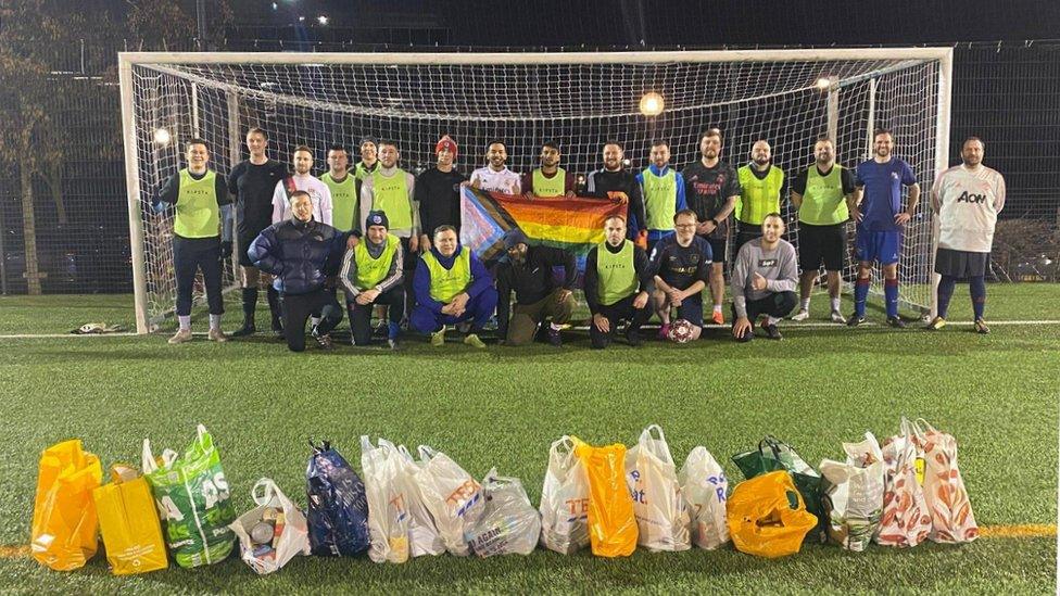 Football pitch with players in goal and food donations