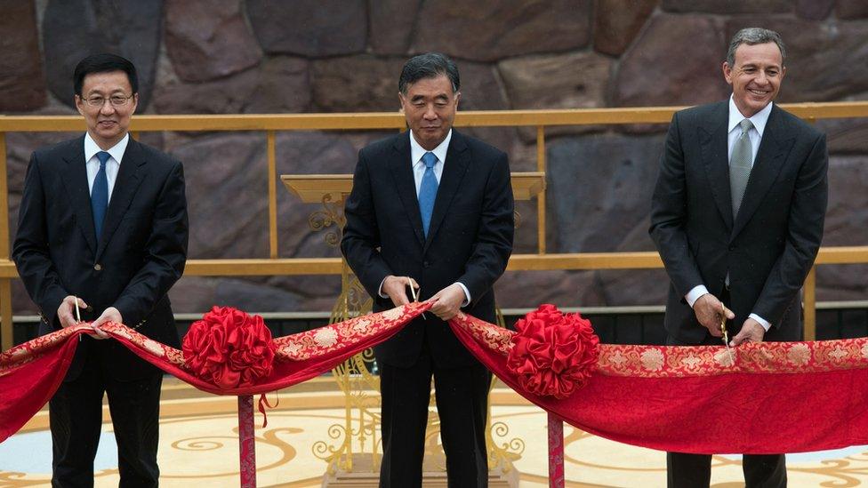 (L to R) Shanghai Mayor Han Zheng, Chinese Vice Premier Wang Yang and chairman and CEO of Walt Disney, Bob Iger, cut a red ribbon during the opening ceremony for the Shanghai Disney Resort in Shanghai on June 16, 2016.